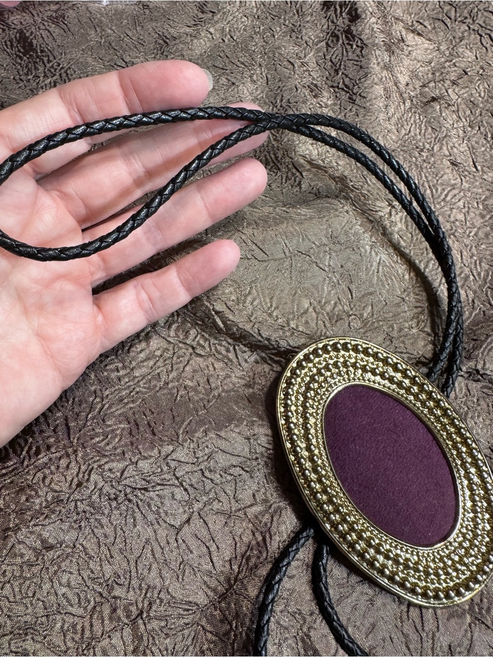 Men's bolo with Gold  colored Oval Pendant and Plum Center